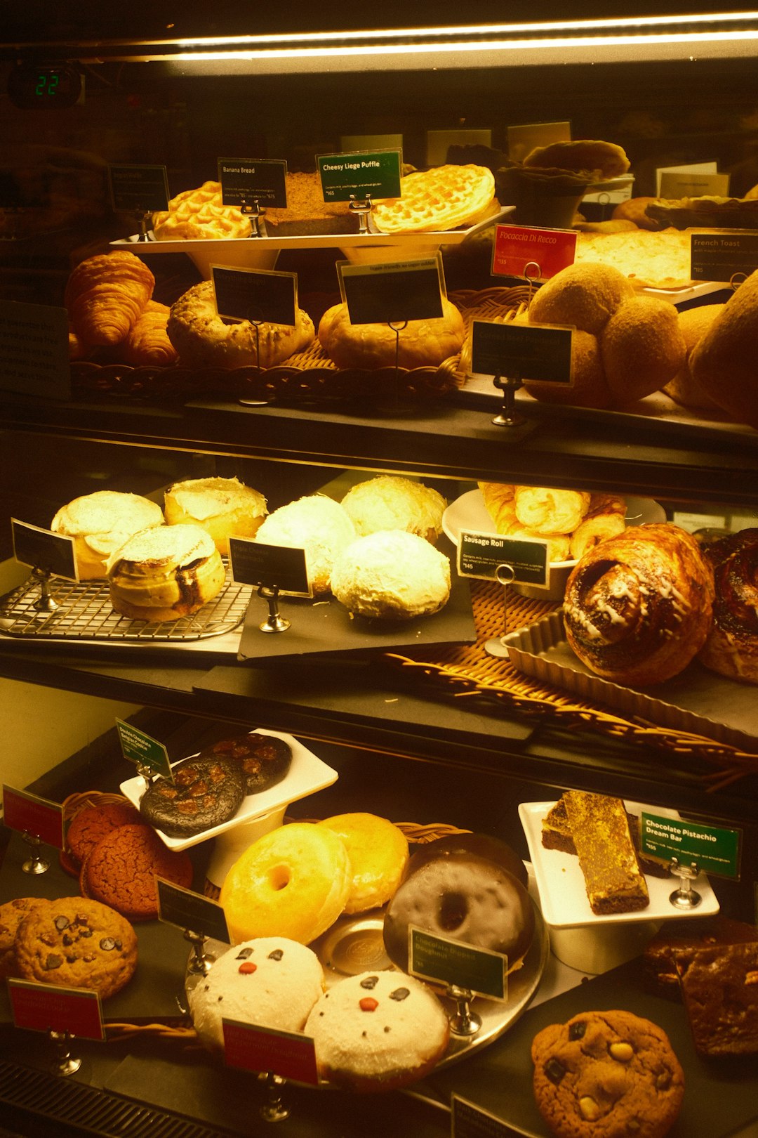 Pastries and donuts arranged in a display case